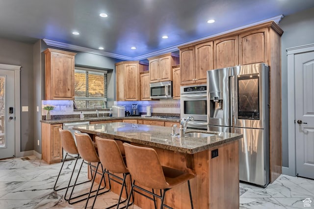 692 N Harrison Blvd, Ogden, UT 84404 - kitchen with stainless steel appliances, a sink, light marble finish flooring, dark stone countertops, and a kitchen island with sink