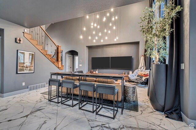 692 N Harrison Blvd, Ogden, UT 84404 - kitchen featuring arched walkways, marble tiled floors, and a high ceiling
