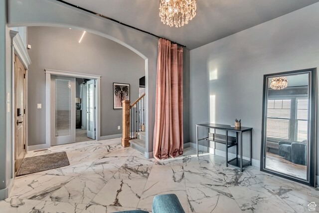 692 N Harrison Blvd, Ogden, UT 84404 - living room with arched walkways, stairs, baseboards, and marble finish floors