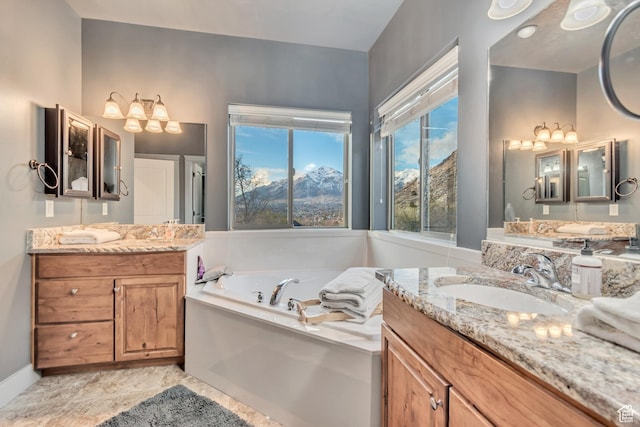 692 N Harrison Blvd, Ogden, UT 84404 - bathroom with a garden tub, two vanities, a chandelier, baseboards, and a mountain view