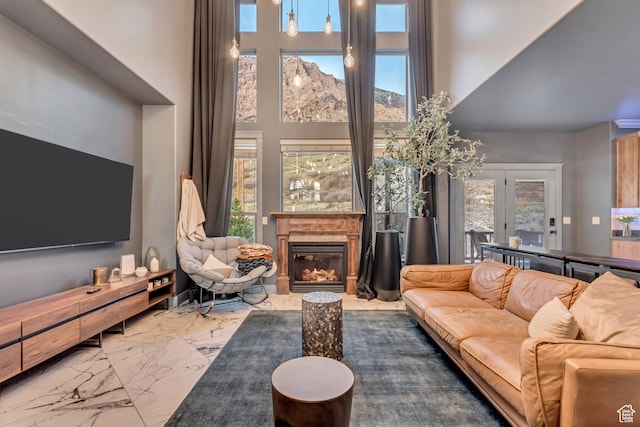 692 N Harrison Blvd, Ogden, UT 84404 - living area with marble finish floors, a high ceiling, and a glass covered fireplace