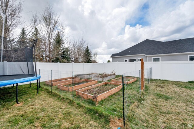 3225 N 1000 W, Pleasant View, UT 84414 - view of yard with fence, a garden, and a trampoline