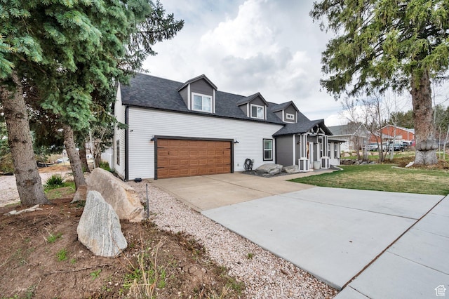 3225 N 1000 W, Pleasant View, UT 84414 - view of front of home with driveway, an attached garage, a front lawn, and roof with shingles
