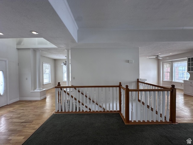 28848 N 11170 E, Milburn, UT 84629 - interior space featuring a textured ceiling, an upstairs landing, decorative columns, and plenty of natural light