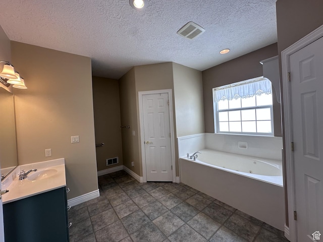 28848 N 11170 E, Milburn, UT 84629 - bathroom featuring a tub with jets, vanity, baseboards, and visible vents