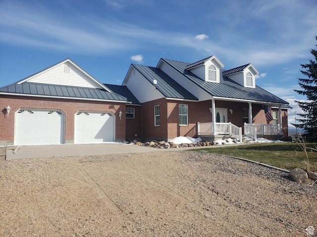 view of front facade featuring dirt driveway, metal roof, a standing seam roof, and brick siding
