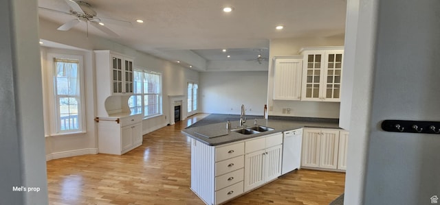 28848 N 11170 E, Milburn, UT 84629 - kitchen with a sink, light wood finished floors, a ceiling fan, a peninsula, and white dishwasher