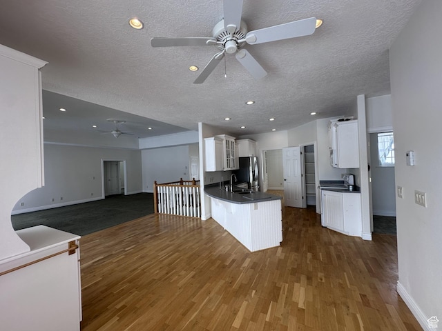 28848 N 11170 E, Milburn, UT 84629 - kitchen with freestanding refrigerator, a ceiling fan, a peninsula, and dark countertops