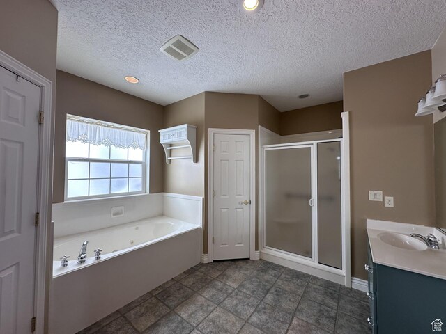 28848 N 11170 E, Milburn, UT 84629 - full bathroom with a shower stall, a tub with jets, a textured ceiling, baseboards, and visible vents