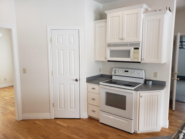 28848 N 11170 E, Milburn, UT 84629 - kitchen featuring white cabinetry, dark countertops, light wood finished floors, and white appliances