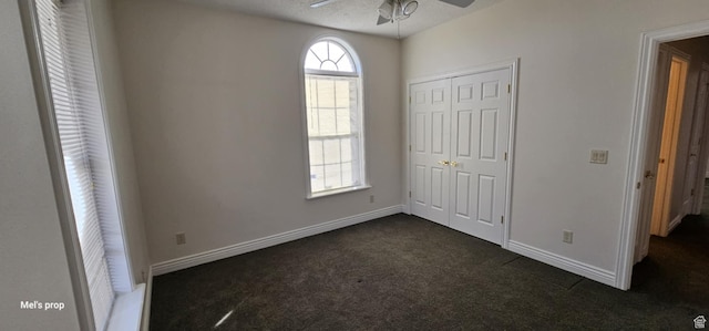 28848 N 11170 E, Milburn, UT 84629 - unfurnished bedroom featuring a ceiling fan, a closet, baseboards, and dark colored carpet