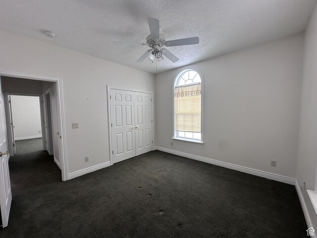 28848 N 11170 E, Milburn, UT 84629 - unfurnished bedroom with baseboards, dark colored carpet, ceiling fan, and a textured ceiling