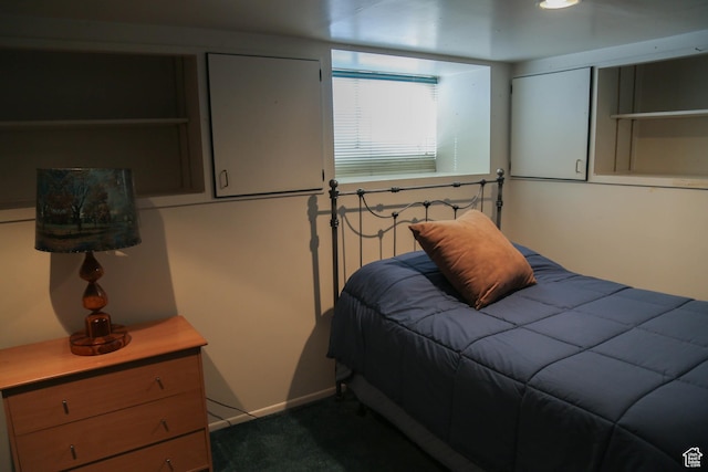 bedroom featuring baseboards and dark colored carpet