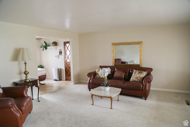 carpeted living room featuring tile patterned floors, baseboards, and visible vents