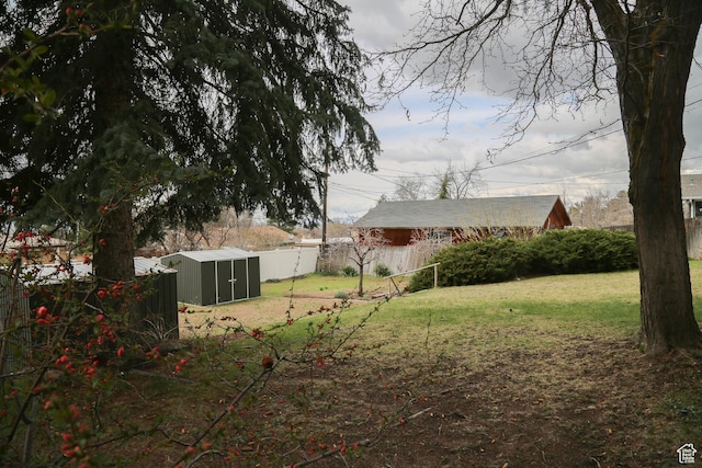 view of yard with an outdoor structure and fence