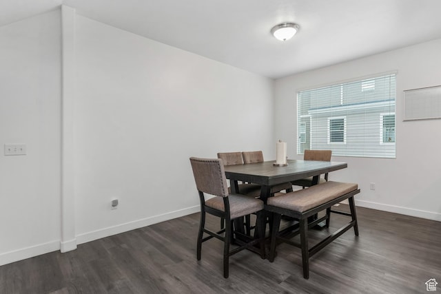 dining room featuring baseboards and dark wood-style flooring