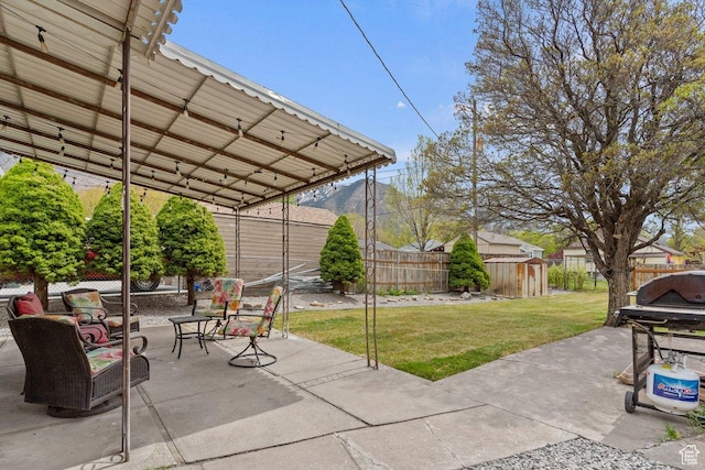 1335 Swan St, Ogden, UT 84401 - view of patio / terrace with a fenced backyard, a storage unit, and an outdoor structure