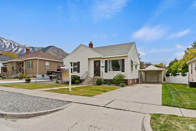 1335 Swan St, Ogden, UT 84401 - bungalow-style home with a chimney, a mountain view, an outbuilding, fence, and a garage