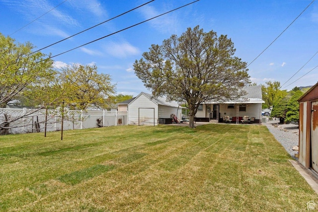 1335 Swan St, Ogden, UT 84401 - view of yard featuring an outdoor structure, fence, and a patio