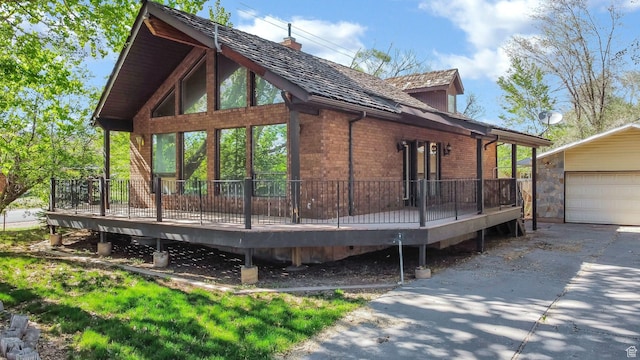 605 E 400 N, Richfield, UT 84701 - view of home's exterior featuring a wooden deck, brick siding, an outbuilding, and a chimney