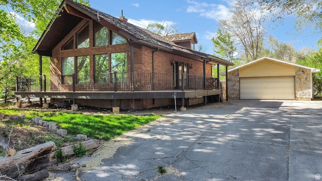 605 E 400 N, Richfield, UT 84701 - view of side of property featuring a detached garage, an outdoor structure, brick siding, and a wooden deck