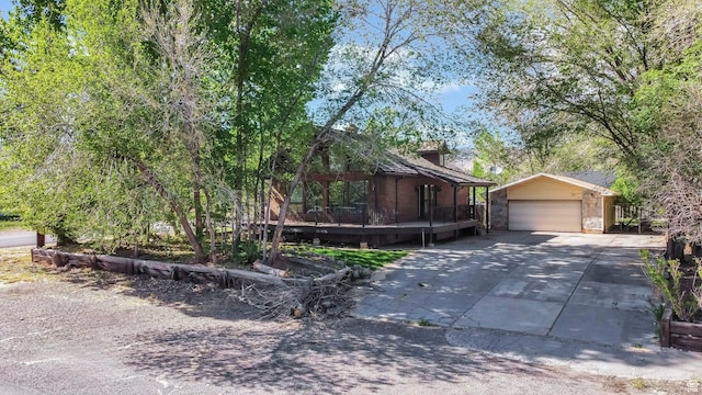 605 E 400 N, Richfield, UT 84701 - view of front facade featuring an outbuilding, concrete driveway, and a deck