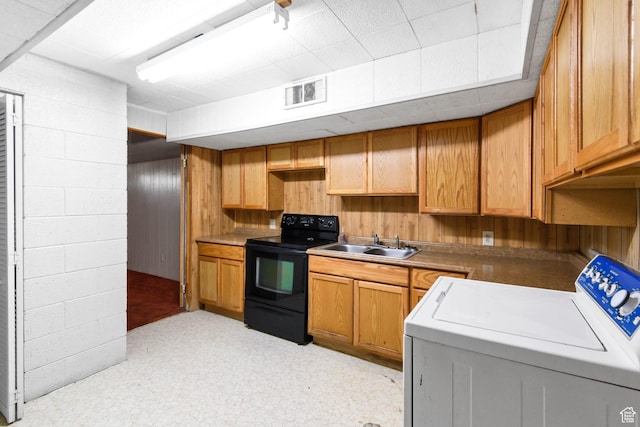 605 E 400 N, Richfield, UT 84701 - kitchen featuring washer / dryer, black / electric stove, a sink, wood walls, and light floors