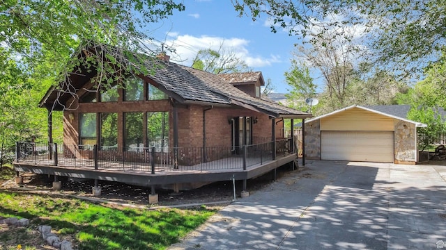 605 E 400 N, Richfield, UT 84701 - view of side of home with an outdoor structure, a wooden deck, a detached garage, and brick siding