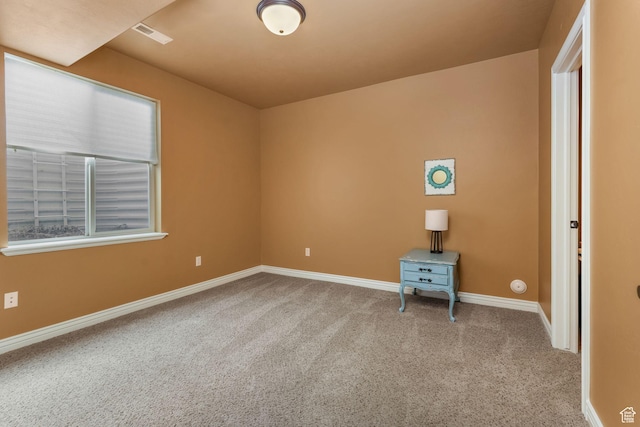 carpeted empty room with a healthy amount of sunlight and baseboards