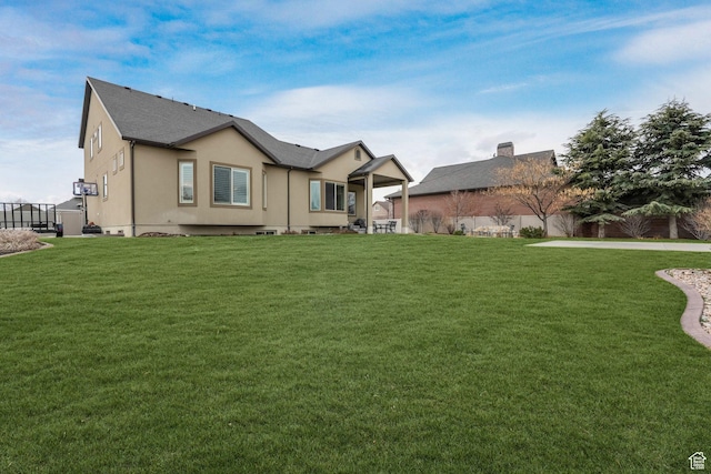 back of house featuring fence and a yard