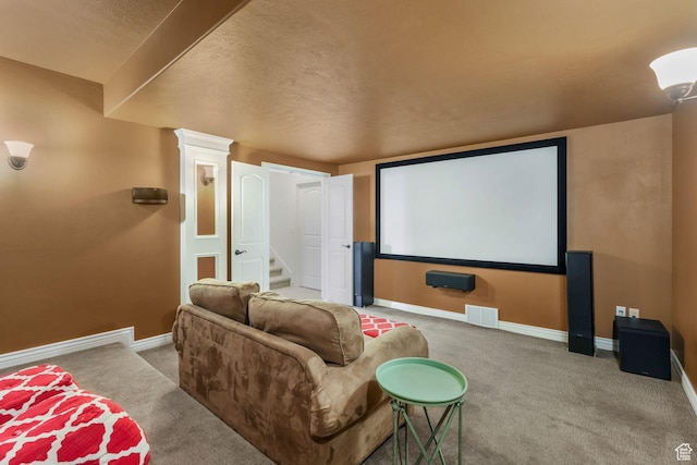 cinema with baseboards, visible vents, and carpet
