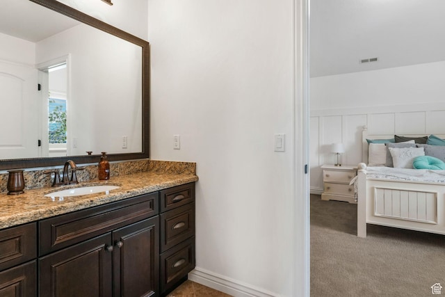 bathroom featuring wainscoting, vanity, and visible vents