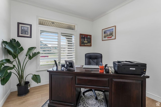 office with crown molding, light wood-style floors, and baseboards