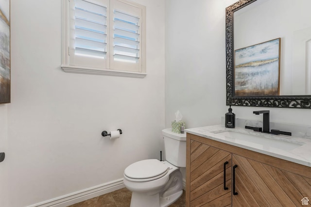 bathroom with baseboards, toilet, vanity, and tile patterned floors