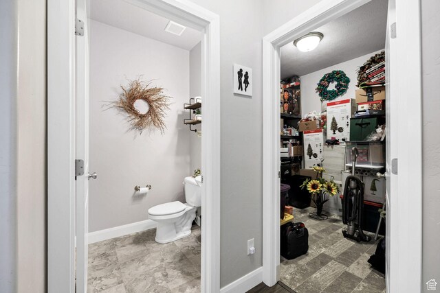 802 W 1060 S, Logan, UT 84321 - bathroom featuring baseboards, visible vents, and toilet