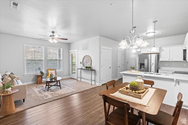 1816 W Eaglewood Dr Unit 101, Saratoga Springs, UT 84045 - dining room with ceiling fan with notable chandelier, wood finished floors, and a textured ceiling