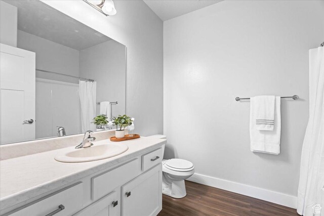 1816 W Eaglewood Dr Unit 101, Saratoga Springs, UT 84045 - full bathroom featuring toilet, vanity, baseboards, and wood finished floors