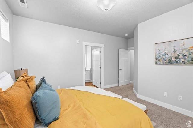 1816 W Eaglewood Dr Unit 101, Saratoga Springs, UT 84045 - bedroom featuring light colored carpet, a textured ceiling, ensuite bathroom, baseboards, and visible vents