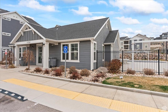 1816 W Eaglewood Dr Unit 101, Saratoga Springs, UT 84045 - view of front of property with fence, board and batten siding, a residential view, a shingled roof, and a garage