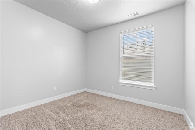 1816 W Eaglewood Dr Unit 101, Saratoga Springs, UT 84045 - unfurnished room featuring baseboards, carpet flooring, a textured ceiling, and visible vents