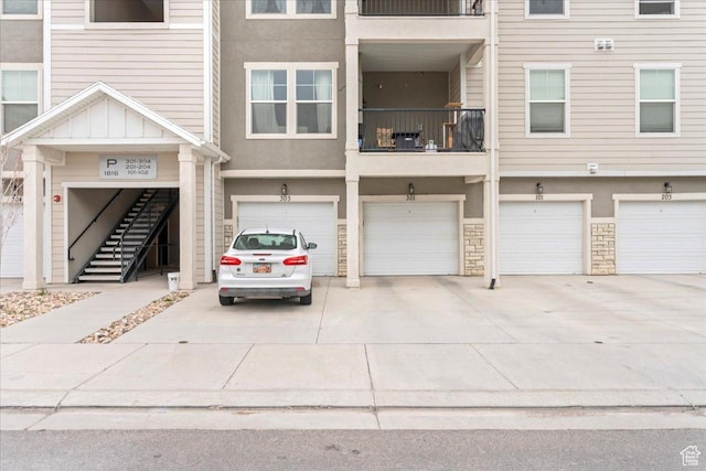 1816 W Eaglewood Dr Unit 101, Saratoga Springs, UT 84045 - multi unit property with stucco siding, stairs, stone siding, driveway, and a garage