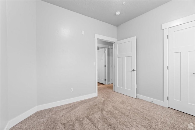 1816 W Eaglewood Dr Unit 101, Saratoga Springs, UT 84045 - unfurnished bedroom featuring baseboards, carpet, and a textured ceiling