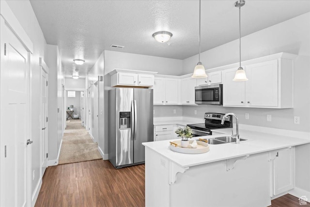 1816 W Eaglewood Dr Unit 101, Saratoga Springs, UT 84045 - kitchen with light countertops, visible vents, white cabinets, a peninsula, and appliances with stainless steel finishes