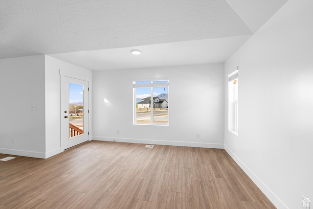 1651 E 900 N Unit 16, Spanish Fork, UT 84660 - spare room featuring visible vents, light wood-style flooring, baseboards, and a textured ceiling