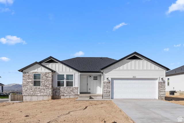 1651 E 900 N Unit 16, Spanish Fork, UT 84660 - view of front of home with board and batten siding, an attached garage, and stone siding