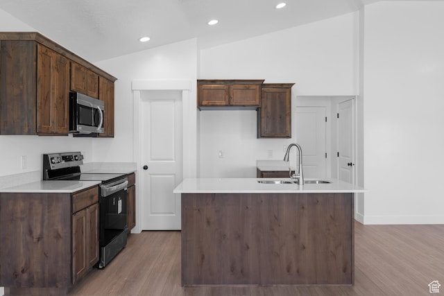 1651 E 900 N Unit 16, Spanish Fork, UT 84660 - kitchen with stainless steel microwave, vaulted ceiling, range with electric stovetop, light wood finished floors, and a sink