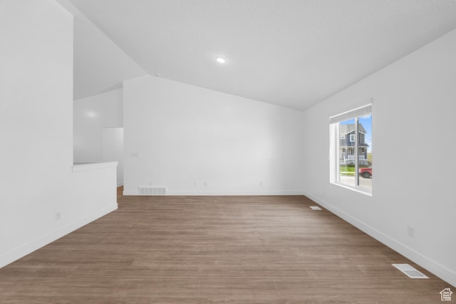 1651 E 900 N Unit 16, Spanish Fork, UT 84660 - unfurnished room featuring wood finished floors, baseboards, lofted ceiling, and visible vents