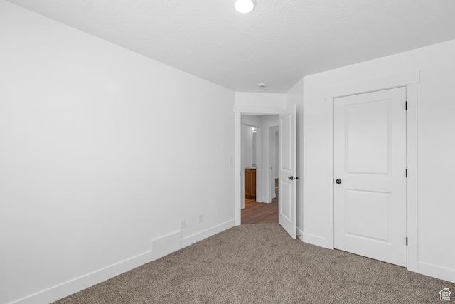 1651 E 900 N Unit 16, Spanish Fork, UT 84660 - unfurnished bedroom with a closet, baseboards, carpet flooring, and a textured ceiling