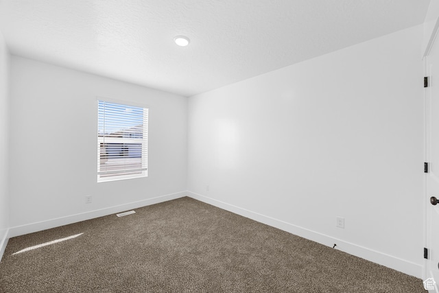 1651 E 900 N Unit 16, Spanish Fork, UT 84660 - spare room featuring dark colored carpet, visible vents, baseboards, and a textured ceiling