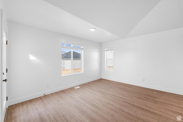 1651 E 900 N Unit 16, Spanish Fork, UT 84660 - empty room with lofted ceiling, light wood-type flooring, baseboards, and a textured ceiling